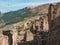 Authentic ruins of an ancient settlement. Summer view of ruins and towers of the aul ghost Goor in Dagestan in the evening light.