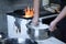 Authentic rustic lifestyle, woman cooking on an old wood stove