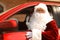 Authentic Santa  driving his modern car, outdoors