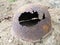 Authentic Second World War helmet with bullet hole. Rusty helmet on the grave - memorial in Orzega, Karelia. Helmet of a
