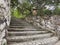 Authentic staircase in jungle.Steps leading to tropical park. Masonry and stone walls. Old jug among the trees. Close-up