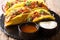 Authentic tacos with glazed chicken, microgreen and vegetables are served with sauces close-up. horizontal