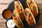 Authentic tacos with glazed chicken, microgreen and vegetables are served with sauces close-up. horizontal top view