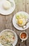 Authentic Thai dinner background: Tom kha gai spicy soup, plain rice and pad kra pao with fried egg on top and homemade chilli sau