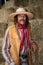 Authentic western cowboy with leather vest, cowboy hat and scarf portrait