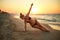 Authentic woman in swimsuit doing yoga vasisthasana on the beach in the morning. Real unretouched shape girl silhouette