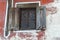 Authentic wooden antique street window with iron grating, town Koprivshtitsa