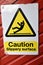 Authentic yellow black and white sign for caution slippery surface
