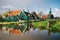 Authentic Zaandam mills and traditional vibrant houses on the water canal in Zaanstad village, Netherlands