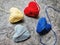 Autism awareness. Four knitted hearts on dark background.