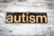 Autism Letterpress Word on Wooden Background