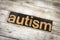 Autism Letterpress Word on Wooden Background