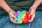 Autistic boy using rainbow pop it fidget toy. Push bubble fidget sensory toy - washable and reusable silicon stress