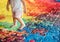 Autistic child walking on the floor formed by a puzzle with vibrant colors. World Autism Awareness Day. AI generated