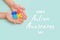 Autistic pride day. The hands of a small child holding colorful puzzles on blue background. Heart of puzzles. Banner