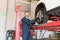 Auto Engineer Fixing Tire Nuts With Electric Spanner In Garage