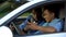 Auto instructor scolding young driver chatting smartphone lesson, safety rules