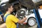 Auto mechanic at car suspension repair work