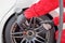 Auto mechanic changing racing car wheel