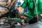 Auto mechanic checking battery for the customers who come to use the battery replacement service at the shop