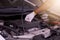 Auto mechanic checking the oil level engine,Maintenance car repair automotive