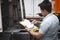 Auto Mechanic is Checking the Semi Truck`s Engine Maintenance Checklist. Lorry Tractor. Inspection Truck Safety Driving.