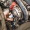 An auto mechanic installs a timing belt idler