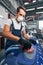 Auto mechanic in respirator using sander on car surface