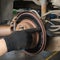 Auto mechanic shows the wear of the brake disc