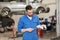 Auto mechanic or smith with wrench at car workshop