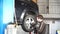 Auto mechanic strengthen wheel with an impact wrench.