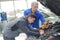 Auto mechanic teacher and trainee performing tests at mechanic school