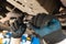 An auto mechanic tightens the oil drain plug in the car crankcase with a torque wrench