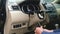 Auto mechanic unscrews the car steering column cover