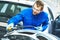 Auto mechanic worker polishing bumper car