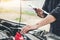 Auto mechanic working in garage Technician holding clipboard and check mechanic Maintenance car check