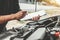 Auto mechanic working in garage Technician holding clipboard and check mechanic Maintenance car check