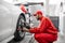 Auto mechanics making wheel alignment at the car service