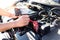 Auto repair technician has inspected the condition of the engine using ammeter