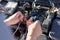 Auto repair technician has inspected the condition of the engine using ammeter