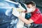 Auto repairman grinding automobile body