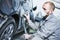 Auto repairman grinding automobile car body