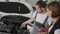 Auto repairman Shows on breakdown vehicle, auto mechanic advises client, woman car broken, service worker talk with