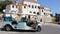 Auto rickshaw `tuk-tuk` in Sintra, the Palace of Sintra in the background, Portugal