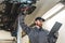 an auto serviceman looking into the papers while chassis inspection in a car workshop, medium closeup