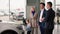 auto shop, young happy family with male child in their arms meets with a manager to choose new car in dealership