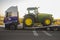 Auto-transport trailer carrying the Row Crop Tractor