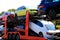 Auto transporter carries new cars of blue, yellow colors from factory. Transportation of cars with specialized trucks and special