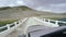 Auto travel: SUV rides on a high mountain road on white bridge over a river. POV - Point of view of a car moving on the