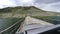 Auto travel: SUV rides on old wooden bridge on a high mountain road. Point of view of a car moving on the road in